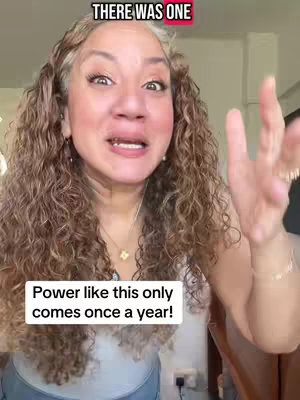 A woman with light skin and long wavy brown hair with gray highlights is centered in the frame, looking directly at the camera and speaking with a gentle expression. She is wearing a light-colored top and a necklace with a small pendant. Behind her, a partially visible room appears to have a window on the right side. Two text overlays are included, one at the top and another at the bottom which are the focus of the image.