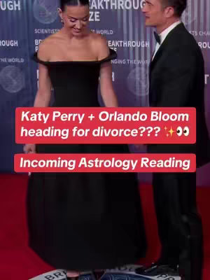 The cover image presents Katy Perry and Orlando Bloom at an event. Katy Perry is wearing a black, off-the-shoulder dress. Orlando Bloom is in a suit, standing beside her on a red carpet. The image has text overlays in red rectangles querying their relationship status and indicating an upcoming astrology reading.