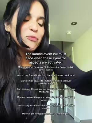 A woman is centered in the frame, with a casual, medium shot. Her hair is long and dark, framing her face. She's wearing a dark top. In the background, there's a light-colored wall and a hint of a doorway, suggesting an indoor setting. Text is superimposed over the image. The woman is speaking, likely addressing the camera.