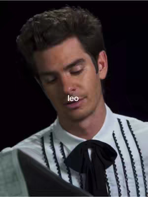 The cover image features a man with dark hair looking down. A text overlay containing the word 'leo' is positioned near his mouth.