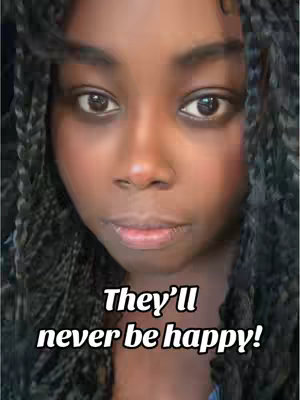 A close-up shot of a woman's face with dark skin and braided hair. The main focus is on her face, with her eyes looking directly at the viewer. The background is slightly blurred. Text is overlaid on the bottom, declaring the subject's emotional state.