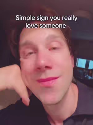 A man with light skin is angled towards the viewer, with his head and elbow resting on his hand. The man is looking directly at the camera, and he has short, dark hair, and the text overlay is at the top.