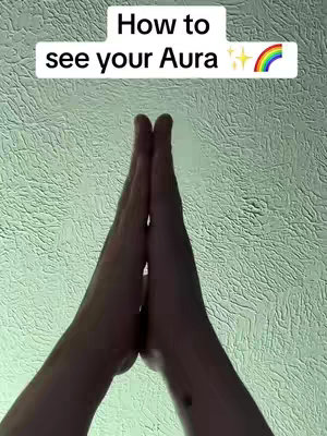 The cover image showcases hands clasped together in a prayer or meditation position, set against a textured light-green background. Above the hands is text with a rainbow graphic.