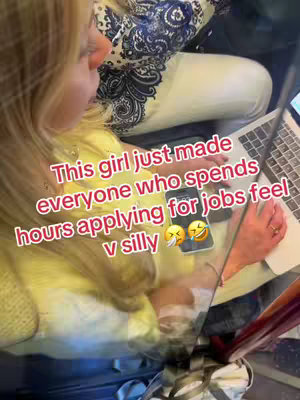 The image shows a woman seated, likely in a public space like a train or plane, working on a laptop. Text overlays are added, while another person is partially visible in the background. The image is well-lit, with the focus on the woman and her laptop.