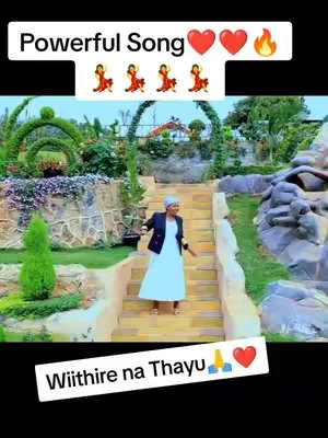 A woman in a light blue dress and a black jacket stands on outdoor stairs in front of a lush garden. Text overlays at the top and bottom promote the video. The overall composition is bright and clean.