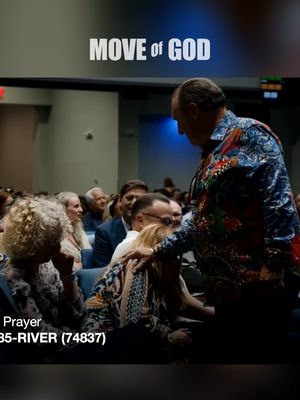 The cover image shows a candid moment at what looks like a religious gathering. A distinguished-looking man with thinning hair, wearing a patterned shirt, is leaning down towards a person, possibly a woman, who is seated among a crowd. The man's hand is resting on the person's head in a gesture that suggests blessing or comfort. The overall lighting is subdued, but there are lights on the ceiling. In the background, other people are seated, creating a sense of community.