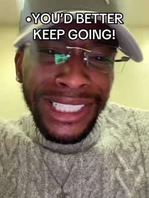 Close-up of a man with a beard, wearing glasses and a cap, looking towards the camera with a slightly concerned expression. A text overlay appears at the top.