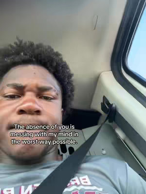 A selfie style shot taken from inside a car. A young Black man with a concerned expression is in the foreground. Overlayed text appears in the bottom left corner.