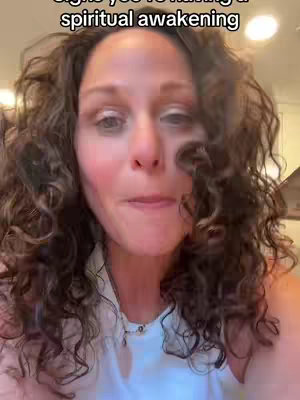 A woman with curly brown hair is the focus, with text overlayed at the top describing a spiritual awakening.