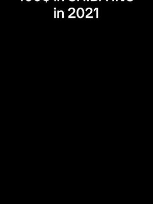 The cover image is a simple graphic with a black background. Centered towards the top is white text, likely the title of the video, which reads, "100$ in SHIBA INU in 2021". The font appears to be a simple sans-serif style. The overall composition is minimalist, focusing solely on the text for immediate impact.