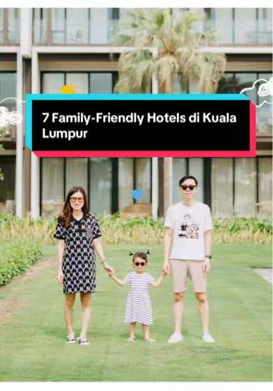 A family of three posing in front of a modern building. A text overlay provides the video's title. The family is standing on green grass. The mother wears a patterned dress, the father wears a white shirt and sunglasses, and the child wears a striped outfit, all holding hands.