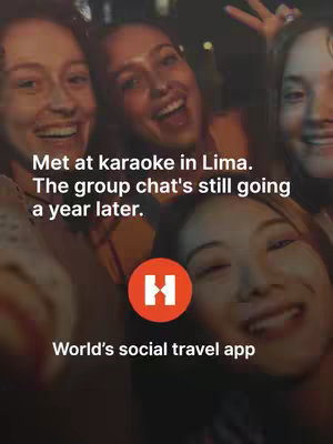 A selfie-style photo taken in a dimly lit environment, likely a social gathering. Features multiple women smiling and looking towards the camera. Text overlays indicate the context of the image: a karaoke gathering in Lima and the lasting friendship formed. The logo of Hostelworld, a social travel app, is also featured.