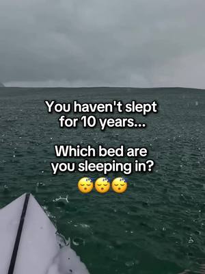 The image captures a view from a boat on a wavy, grey ocean under a dark, stormy sky. The text overlay poses a question about sleeping in a bed after not sleeping for ten years, with three sleeping-face emojis below.