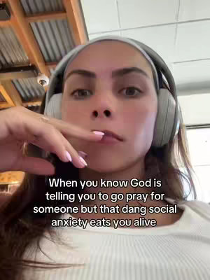 A woman with brown hair is wearing headphones and looking at the camera. She touches her lip with one finger. Text overlays the image.