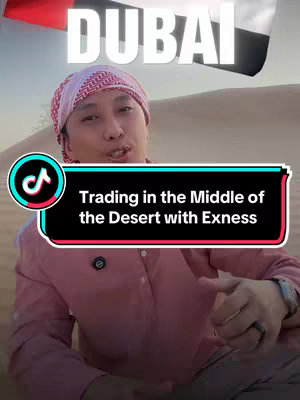 A selfie-style video in the desert of a man wearing traditional headwear, with the text 'Trading in the Middle of the Desert with Exness'. The background features desert sand and a blurred sky, in the background a flag of UAE can be partially seen.