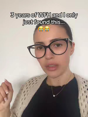 A woman with black-framed glasses and a casual outfit is centered in the frame. Above her, text overlays read, "3 years of WFH and I only just found this..." along with two crying laughing emojis. The background is plain white.