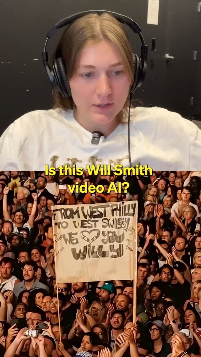 A woman wearing headphones is centered in the frame, facing forward and talking to the camera. Behind her is a dark background. Below her is an image of a crowd of people at an event, holding up a sign that reads "From West Philly to West Swilly, We Love You Will!"