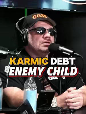 The cover image features a man wearing a black cap with white text and sunglasses, speaking into a microphone. Overlayed on the image is the text "KARMIC DEBT ENEMY CHILD". The man is in front of a blurred background.