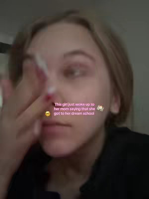 The cover image shows a close-up of a young woman's face. She appears to have just woken up, with her hand partially covering her face. The overlaid text indicates the video potentially involves the creator's dream school. The color palette is natural with soft lighting.