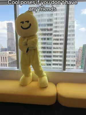 A person in a yellow lemon costume poses on a yellow bench by a window. Text on the top reads, "Cool poses if you don't have any friends."