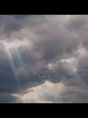 An image of a cloudy sky with beams of light piercing through the clouds. The word Libra is displayed in the middle of the screen