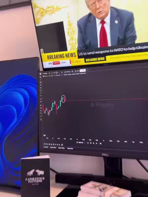 The cover image shows a setup with multiple computer screens displaying financial charts, news, and related content. A screen on the right shows a candlestick chart with analysis, while a screen on the left exhibits a blue design. A news broadcast featuring Donald Trump plays on a TV above, adding a real-time context to the scene. Additionally a book of 'Candlestick Patterns' sits on the table.