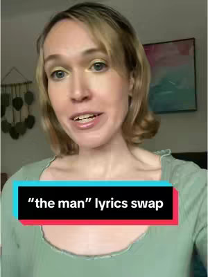A woman with light skin and blonde hair is looking directly at the camera. She is wearing a light green top. Below her is a black and red rectangle containing text that says '"the man" lyrics swap'.