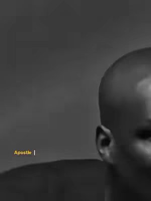 The cover image is a black and white portrait of a man. The man is bald and his head is mostly filling the right side of the frame. He has dark skin. The background is a grey gradient. The text "Apostle |" is also in the image, in yellow color.