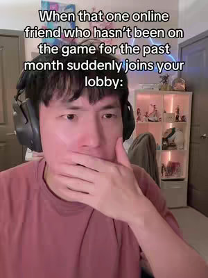 The cover image features a young Asian man in a selfie-style shot. He is wearing a pink t-shirt and black headphones and has a hand covering his mouth, suggesting surprise or a secret. The background is blurred, with a hint of a room that includes a cabinet with figurines and decorative items. Text overlays are visible, describing the scenario.