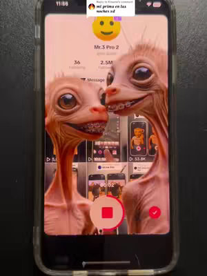 A smartphone displaying a TikTok video is held in the center; the phone's screen shows a surreal image of two humanoid creatures with pale skin, large eyes, and visible braces, seemingly interacting in an emotional manner. The background contains a mix of interface elements and video thumbnails. Overlaid are the creator's username and content statistics.