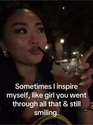 A woman is captured in a close-up shot, holding a cocktail while drinking through a straw. She is looking to the side with a contemplative expression while the overlaid text offers inspirational words.