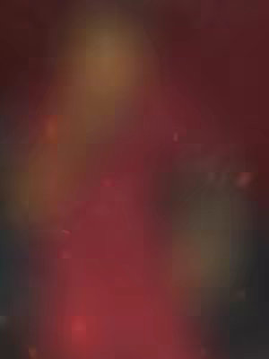 A blurred image dominated by warm colors such as red, orange and yellow, with an ambient light quality and no distinct shapes or objects visible. It gives an impression of abstract art or atmospheric visual.