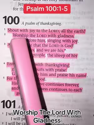 The image shows an open book with highlighted text. A pink highlighter pen partially obscures the text. At the top, a red rectangular label reads 'Psalm 100:1-5'. Underneath, the text includes a psalm of thanksgiving. The lower portion of the image features the words 'Worship The Lord With Gladness' in a smaller, bolder font.