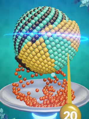 The image showcases a brightly colored, 3D-rendered sphere composed of numerous small balls, with a palette featuring teal, black, yellow, and orange hues. The sphere sits atop a silver dish from which smaller, orange balls are cascading downwards. A golden, needle-like element, labeled '20' at the base, points upwards from the bottom right of the image, suggesting it is part of an interactive game or a level marker.