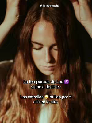 A medium shot features a woman with long, wavy brown hair. She is looking down with her eyes closed. Text overlays are present in the bottom of the image about Leo season and stars. The background appears blurred, enhancing the focus on the woman.