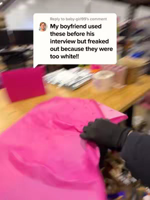 The cover image shows a brightly lit, slightly blurred interior shot. The focus is on a partially visible table covered with a bright pink sheet or fabric. A gloved hand, also with a blurred effect, is visible, touching the fabric. In the background, there are indistinct objects and surfaces, possibly indicating an office or storage space. To the upper left, there's a comment bubble with text overlaid in white font.