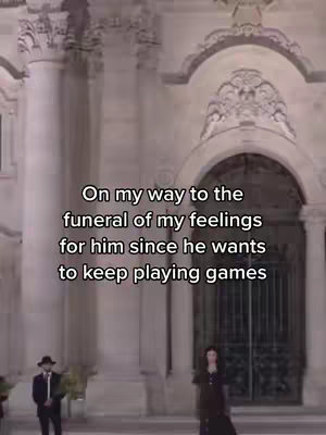 The image shows a tall, ornate building with columns and arched entrances. The words are overlaid in the center. Two figures stand in front of the building, one man in a suit and hat and a woman in a long dress.