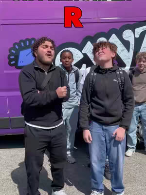 The cover image shows five young men standing in front of a purple van with graffiti. Two of them are in the foreground, looking upwards with expressions of excitement. Above on the image, is a red letter 'R'.