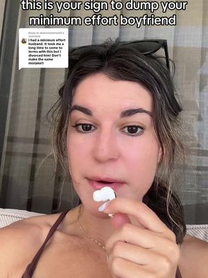 A woman with brown hair is holding a wireless earbud to her lips, in front of her face on the cover of a video about a relationship. She is wearing a brown tank top and a gold necklace. The background is blurred, with some of the text from a comment visible.