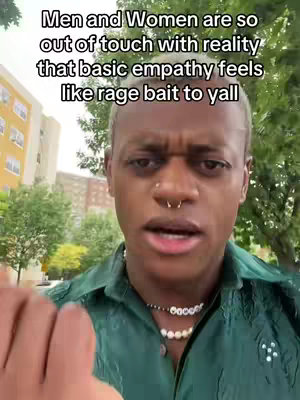A person with short, light hair and nose ring is in front of a blurry outdoor background, wearing a green shirt and a pearl necklace. Text over the person says 'Men and Women are so out of touch with reality that basic empathy feels like rage bait to yall'