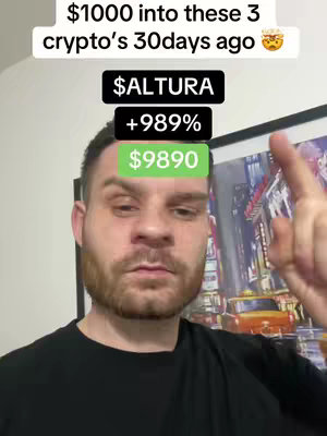 A selfie-style video cover image showing a man in a black shirt and a blurred background of an interior space. Overlaid on the man's face are text boxes displaying financial information about a cryptocurrency investment. The top text box shows "$1000 into these 3 crypto's 30days ago" followed by an emoji. Below, another text box shows "$ALTURA" then "+989%" and the final box shows "$9890". The man is pointing towards the top text box with his right index finger. The overall composition is a portrait with a focus on the man's face and the information to indicate the financial gain of the investment.