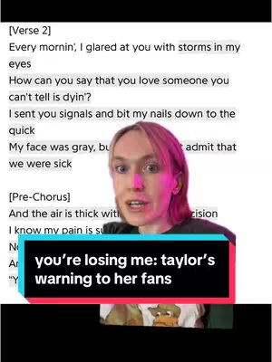 The image is a vertical shot featuring a person with pink hair in the center. Above them is a block of white text, appearing to be song lyrics. The person is looking directly at the camera, and below them is a navy blue text box with white text. The overall composition is simple, with the text overlayed over the person's face.