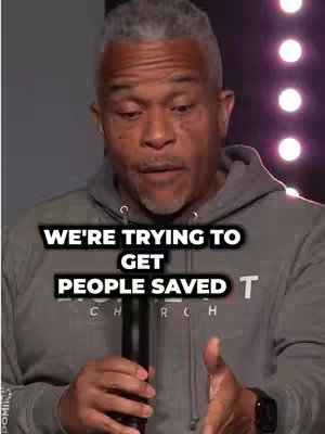 The cover image features a close-up of a man with a serious expression talking into a microphone. Text overlays read 'WE'RE TRYING TO GET PEOPLE SAVED'. The lighting appears to be from behind the subject, with pink and purple lights in the background.