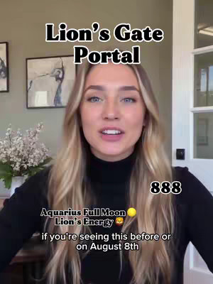 A woman with long blonde hair is shown from the chest up, centered in the frame. White text is superimposed on the image with the words "Lion's Gate Portal" at the top and additional text and numbers towards the bottom, including "888". The background is softly blurred, suggesting a home-like setting with a neutral-toned wall and a window visible on the right. She is speaking, with her mouth open and looking directly at the camera. The overall composition is well-lit and appears to be a selfie video.