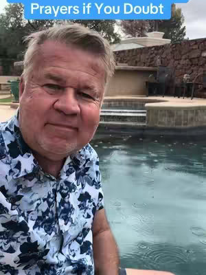 A middle-aged man with short gray hair and a patterned shirt is positioned in front of a pool.