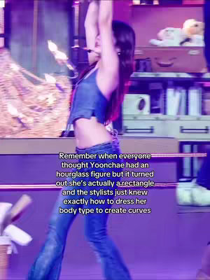 A woman in a denim top and jeans stands in a performance space with her arms raised above her head, her midriff exposed. Text overlays the image describing how a person was thought to have an hourglass figure but is actually a rectangle and the stylists just dress her body type to create curves.