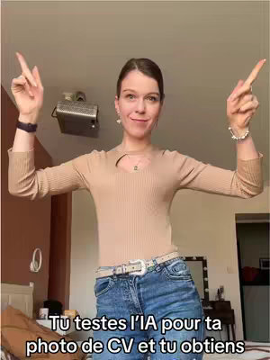A woman is posing in front of a residential backdrop, her arms raised with peace signs. She's wearing a light brown top and blue jeans with a belt. The room has soft lighting, and behind her is a mirror and a bed. Text is overlaid below her, with the beginning words in bold.