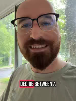 A man with a shaved head and a beard stands in front of a window. The image is a close-up with text overlayed at the bottom.