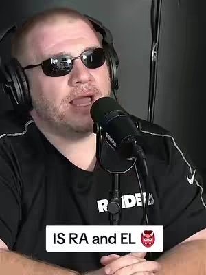 A man wearing sunglasses and headphones speaks into a microphone. The background is dark and out of focus. A text box at the image's bottom reads "IS RA and EL".