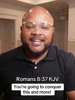A smiling man with glasses is centered in the frame, wearing a black top. Text overlays are present, with a white background with black text at the bottom.